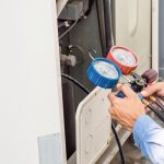 hvac-technician-working-on-air-conditioning-unit